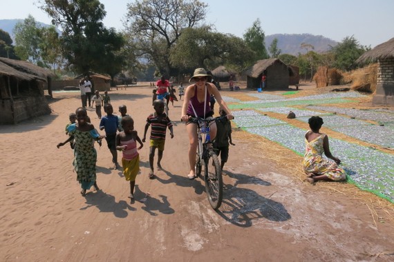 Bike ridding through a village in Malawi